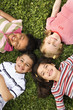 Children Lying in Clover With Heads Together