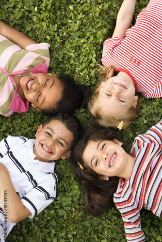 Photo: Children Lying in Clover With Heads Together Children Lying in Clover With Heads Together