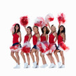 Smiling young cheerleaders posing against white