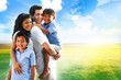 Family of four portrait by a sunset outdoors Family of four portrait by a sunset outdoors
