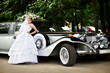 Photo: Luxury bride in a wedding dress about retro limousine Luxury bride in a wedding dress about retro limousine