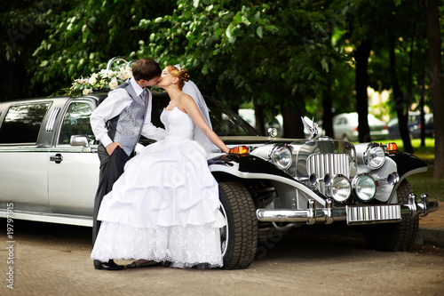 Photo: Groom adn bride about retro limousine Groom adn bride about retro limousine
