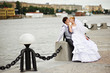 Groom adn bride for walk on embankment river