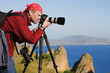 The photographer with the camera on a tripod.