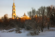 winter landscape with church in sun rays