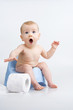 Surprised infant on potty.