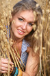 The portrait young woman in the field of wheat.