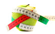 Diet concept. Ripe green apple with measuring tape