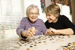 Photo: Elderly Woman and Younger Woman Doing Puzzle Elderly Woman and Younger Woman Doing Puzzle