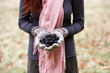 A young woman holding a handful of blackberries