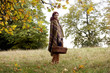 A young woman wrapped in a blanket, holding a wicker basket