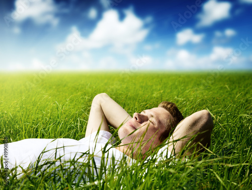 Photo: young man in grass young man in grass