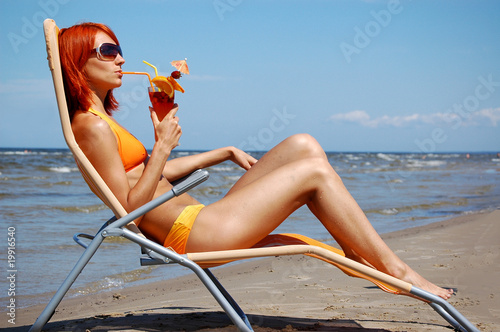 Photo: Beautifl woman with cocktail in lounge Beautifl woman with cocktail in lounge