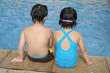 Photo: Kids sitting by the pool Kids sitting by the pool