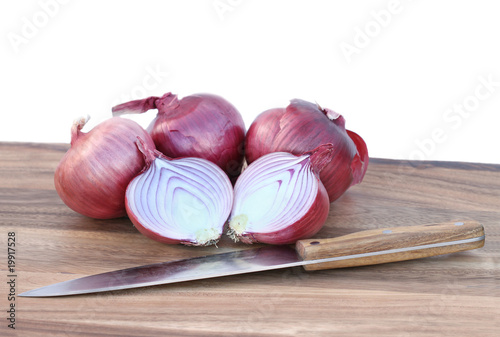 Photo: Spanish onions and knife isolated on white background. Spanish onions and knife isolated on white background.
