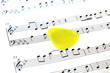 music note paper with yellow guitar pick