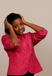 Young African businesswoman holding head