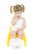 Little curious girl on chamberpot isolated