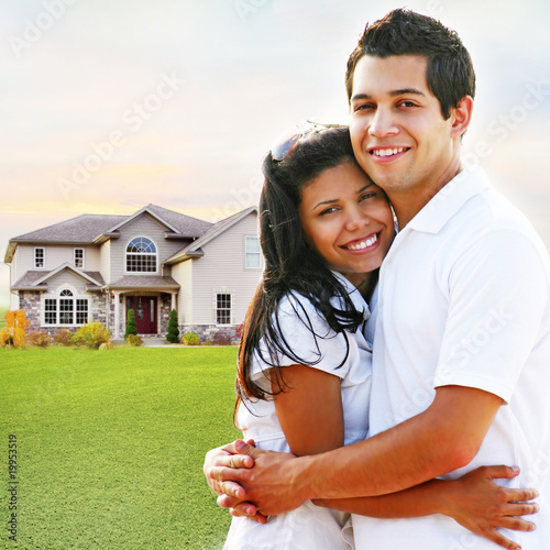 Photo: Happy Couple Embracing in Front of House Happy Couple Embracing in Front of House