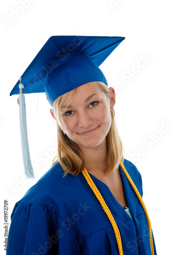 Photo: Teen girl in a blue graduation gown and mortar board Teen girl in a blue graduation gown and mortar board