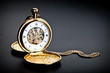 Foto: Old vintage pocket clock against the black background Old vintage pocket clock against the black background