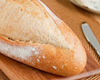 Crisp fresh french bread loaf ready to be cut Crisp fresh french bread loaf ready to be cut
