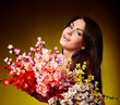 Young woman with group spring flower. Green background.