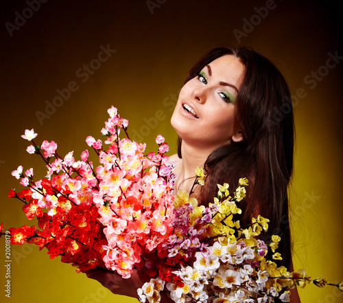 Young woman with group spring flower. Green background.