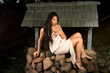 Sensual woman wrapped in scarf outdoors by well
