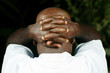 rear view of afro man with fingers clasped behind his head