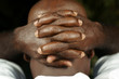 rear view of afro man with fingers clasped behind his head