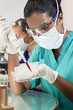 Asian Female Scientist With Pipette & Blood Sample In Laboratory