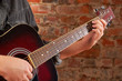 Playing on acoustic guitar