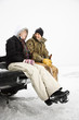 Foto: Young Couple Sitting on Truck Tailgate Young Couple Sitting on Truck Tailgate