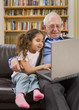 Photo: grandparents and granddaughter with computer grandparents and granddaughter with computer