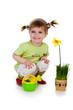 Cute little girl watering yellow flower. Studio shot Cute little girl watering yellow flower. Studio shot