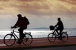 Photo: two bikers on beach and sunset two bikers on beach and sunset