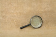 Old black magnifier on drapery background Old black magnifier on drapery background