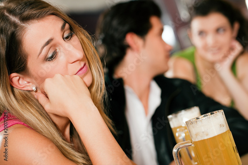 Photo: People in bar, woman being abandoned and sad People in bar, woman being abandoned and sad