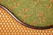 Fragment of sofa against green wall. Interior in retro style