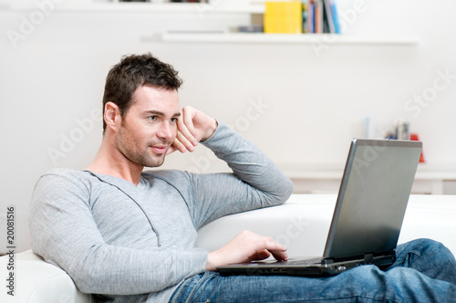 Photo: Young man working on laptop Young man working on laptop