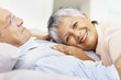 Smiling elderly couple embracing outdoors