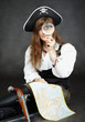 Woman pirate, and map with a magnifying glass on black backgroun Woman pirate, and map with a magnifying glass on black backgroun