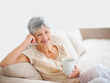 Smiling old woman drinking coffee while at home Smiling old woman drinking coffee while at home