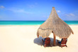 Grass hut and chairs on a gorgeous beach resort