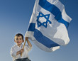 young boy holding the Israeli flag