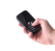 Photo: Hand with black cellphone Hand with black cellphone
