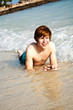 happy boy with red hair is enjoying the beautiful beach