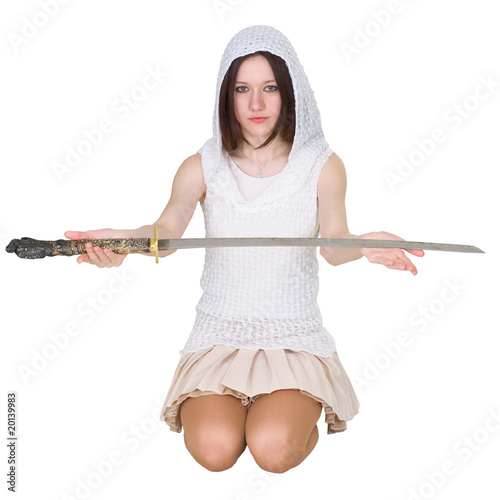 Photo: Teenage girl sitting on the lap with traditional Japanese sword Teenage girl sitting on the lap with traditional Japanese sword