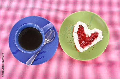 Photo: Cake heart and cup of tea on the table Cake heart and cup of tea on the table